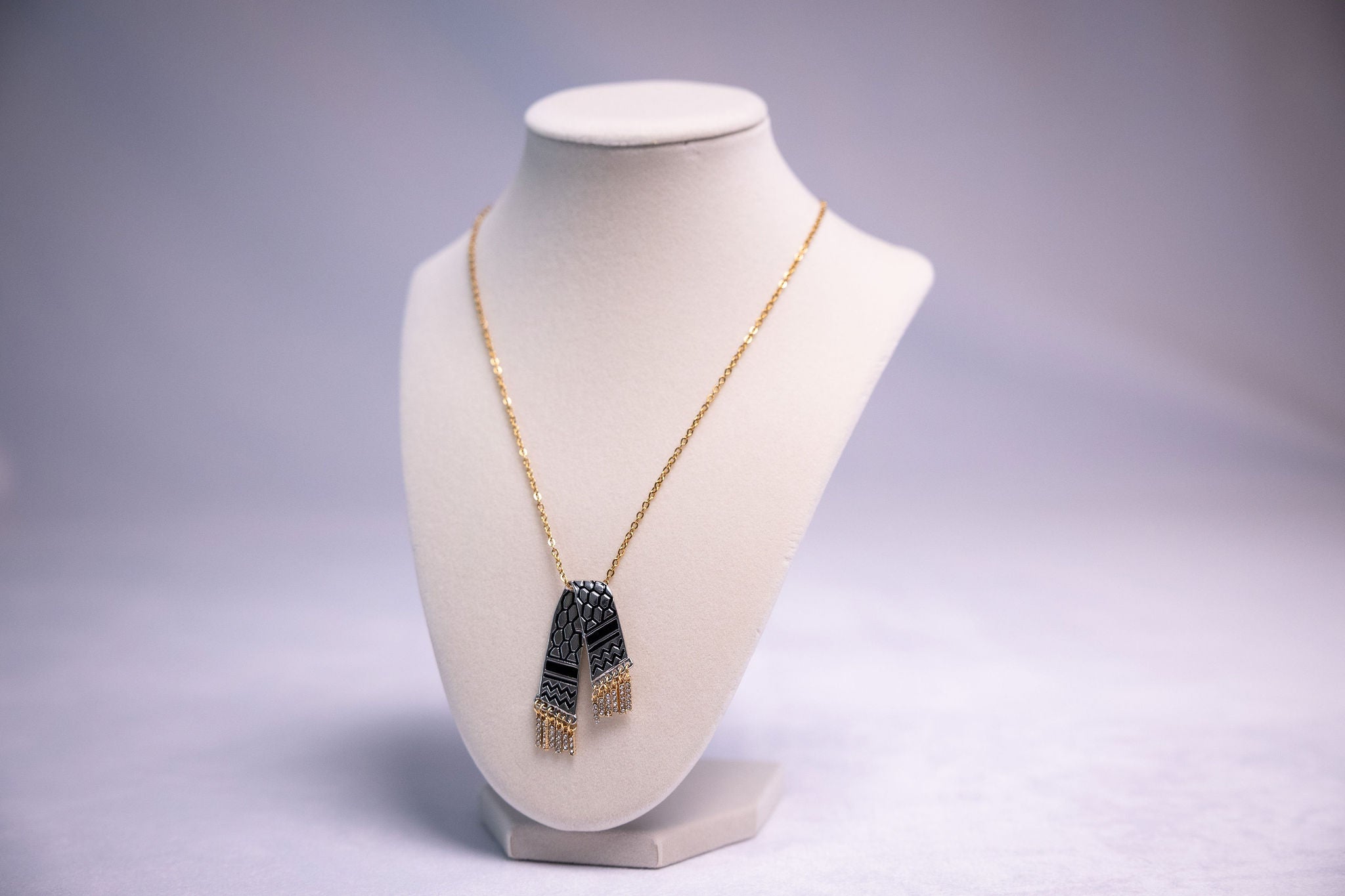 Palestine solidarity charm tassel necklace on a display bust