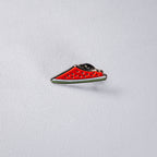The map of Palestine cut in watermelon — red flesh with black seeds, a white band and green rind along the lower edge.