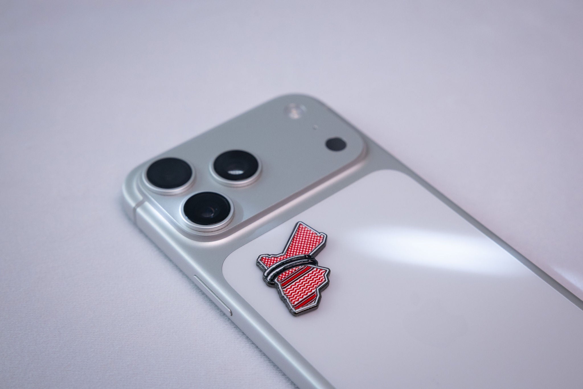 Jordan map in red shemagh pattern with a black band, applied flat to the back of a phone