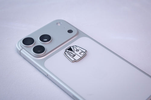 The white coat sticker on the back of a phone.