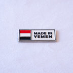 A silver-bordered tag with Yemen’s red, white and black flag on the left and MADE IN YEMEN on the right.