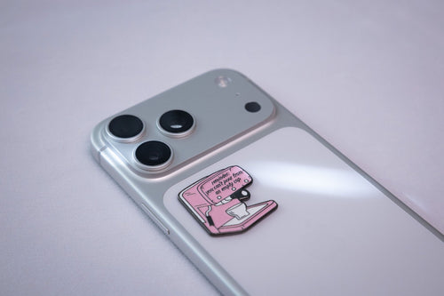 The pink espresso machine sticker on the back of a phone.