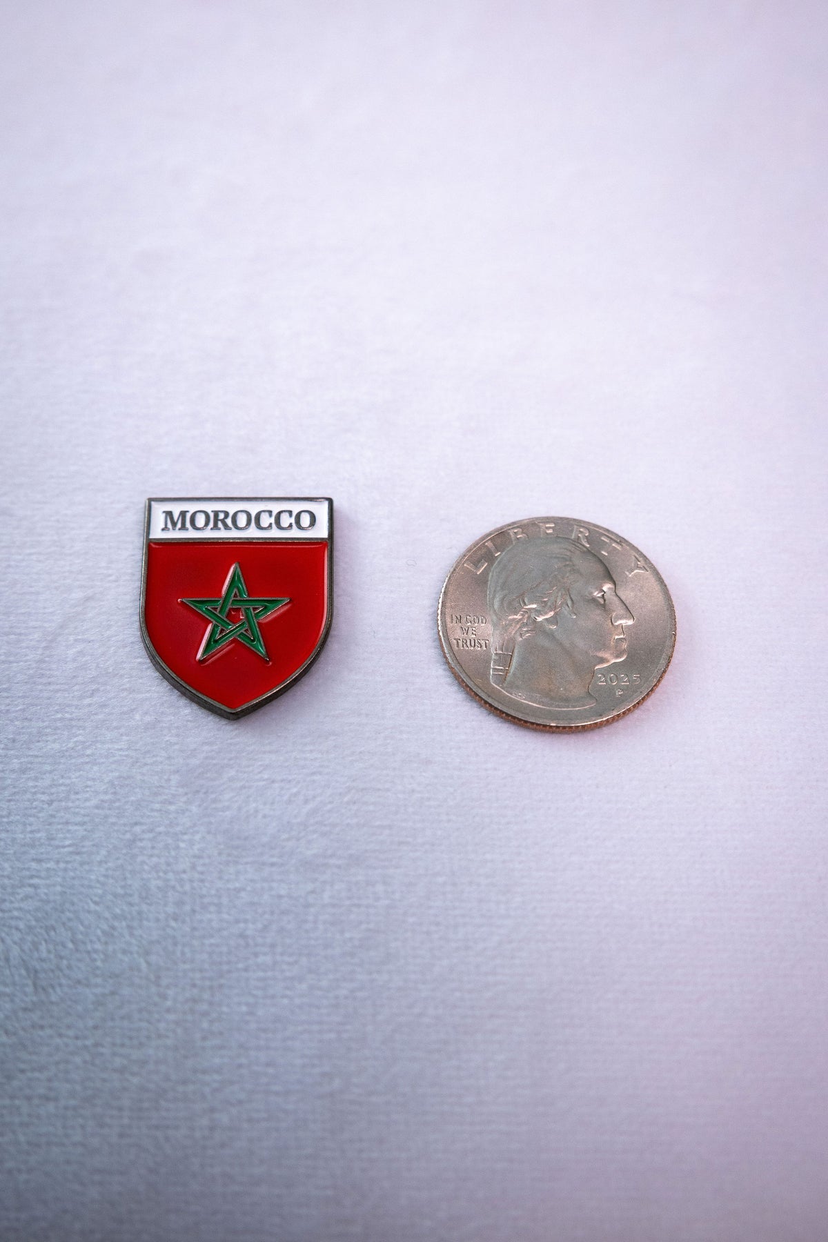 The Morocco Flag Shield sticker beside a US quarter for scale.