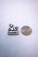 The Kida La' (كده لأ) Over sticker beside a US quarter for scale.