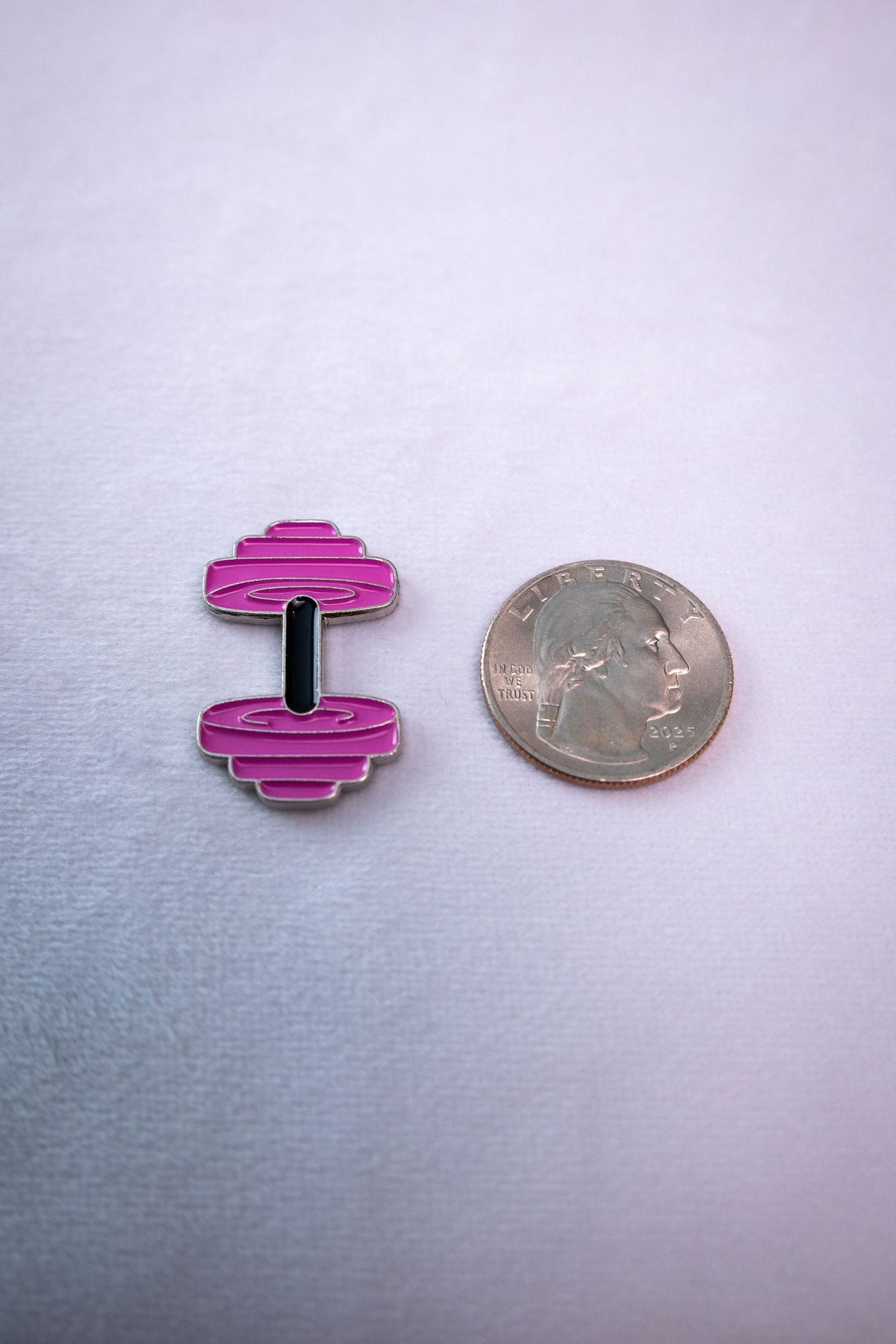 Hot pink/magenta dumbbell metal sticker with black bar (variant KAL-STK-0092-B), on white background next to a quarter for scale — needs to appear on the product page as an alternative finish/colorway