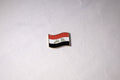 The Iraqi flag mid-wave with التكبير in green Kufic script across the white band.