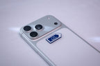 Blue Baghdad (بغداد) road-sign metal sticker, applied to a phone case near the camera bump