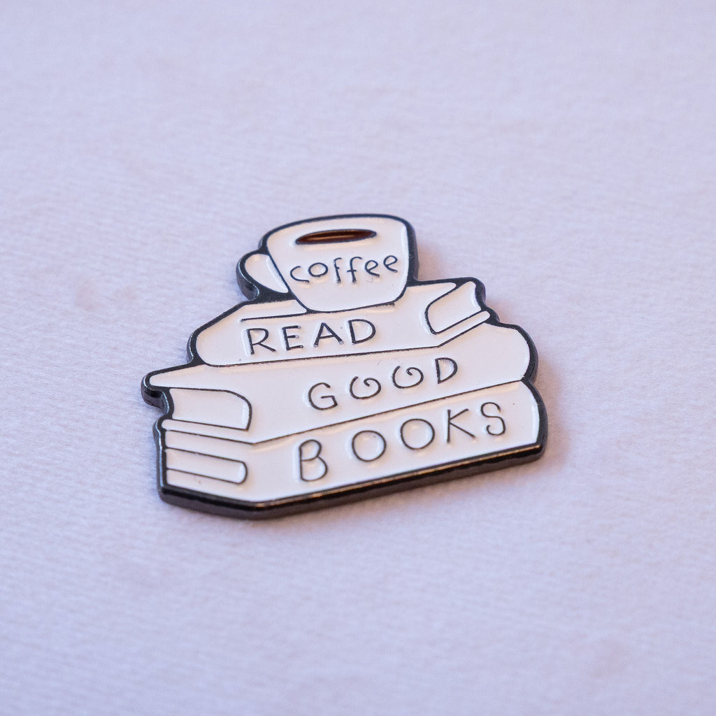 A stack of books beside a cup of coffee above the words READ GOOD BOOKS, as a metal sticker.