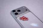 The don't give up metal sticker applied to a phone case near the camera bump.