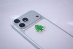 The Lebanon cedar metal sticker applied to a phone case near the camera bump.