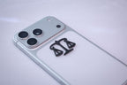 The scales of justice metal sticker applied to a phone case near the camera bump.