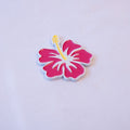 A magenta hibiscus in full bloom with a yellow stamen and a white outline, as a metal sticker.