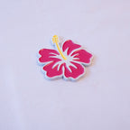 A magenta hibiscus in full bloom with a yellow stamen and a white outline, as a metal sticker.