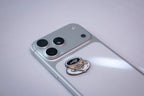 The I Need My Space astronaut teacup metal sticker applied to a phone case near the camera bump.